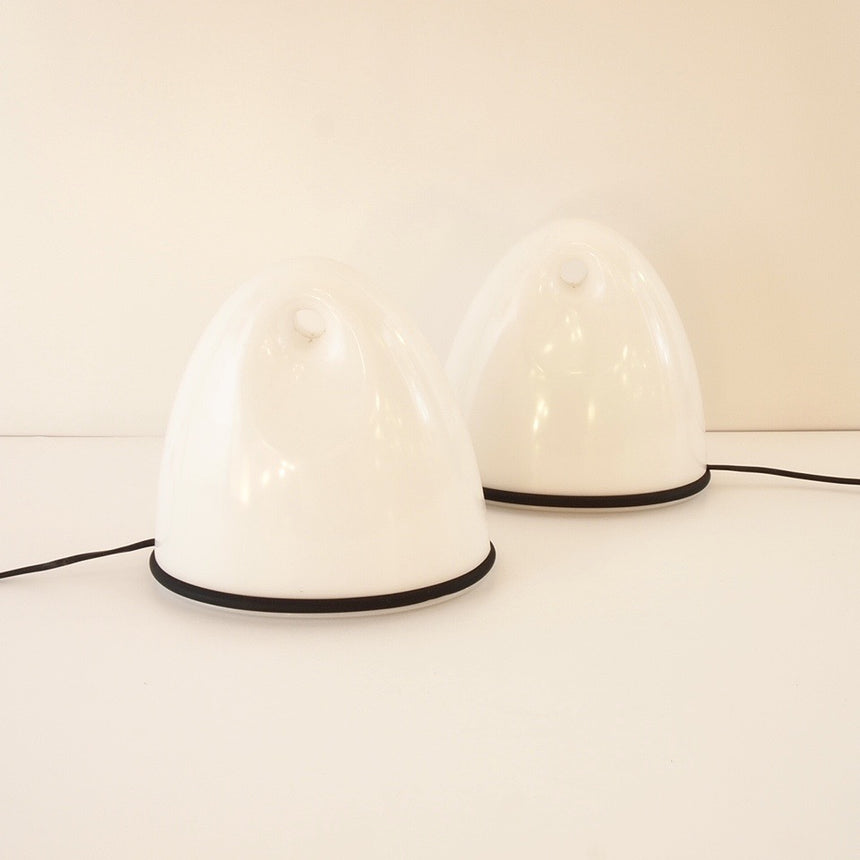 Pair of table lamps designed by Bruno Gecchelin for Guzzini during the 1980's. White plastic with a rubber band that allows the closure of the lamp which is divided into 2 parts. -  Paire de lampe de table dessinées par Bruno Gecchelin pour Guzzini dans les années 80. Plastique blanc avec une bande de caoutchouc qui permet la fermeture de la lampe qui est scindée en 2 parties